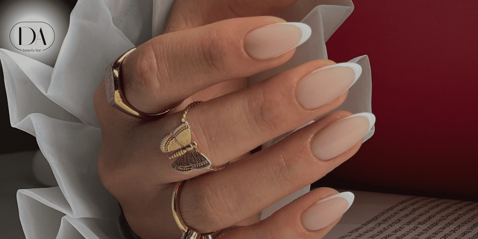 Nude French manicure with gold rings
