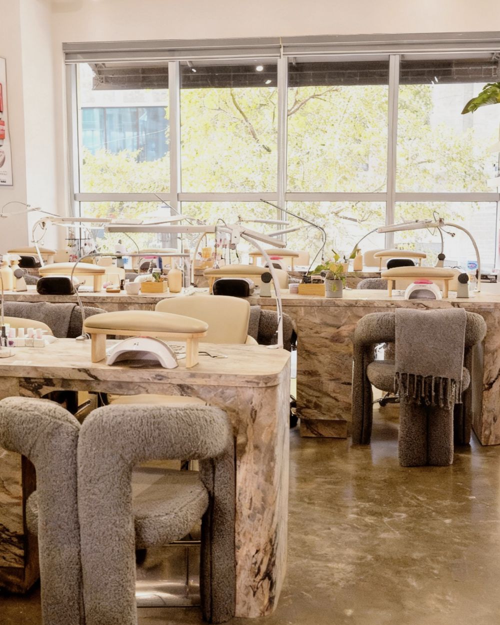 Nail tables by the windows at DA Beauty Bar